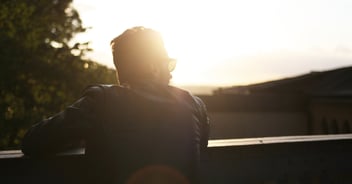 man looking toward sun